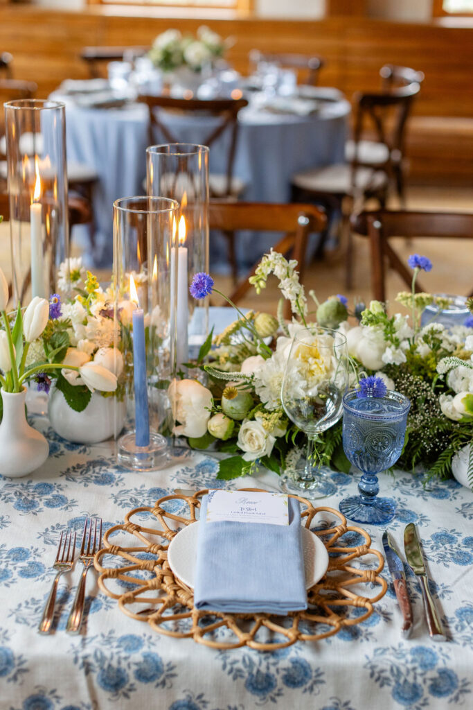 A wedding place setting featuring florals and elegant, bohemian dishware.